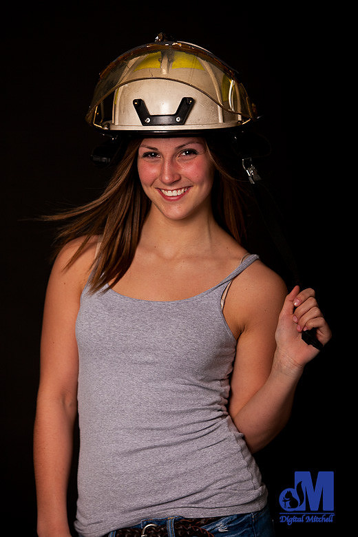 Girl in fireman helmet photograph