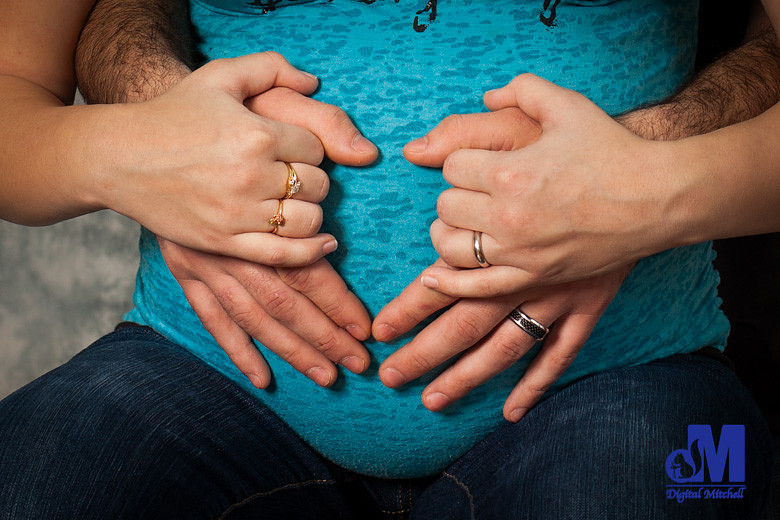 Photograph of maternity with parents hands