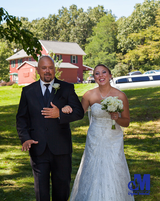 Photograph of bride and father walking down the isle
