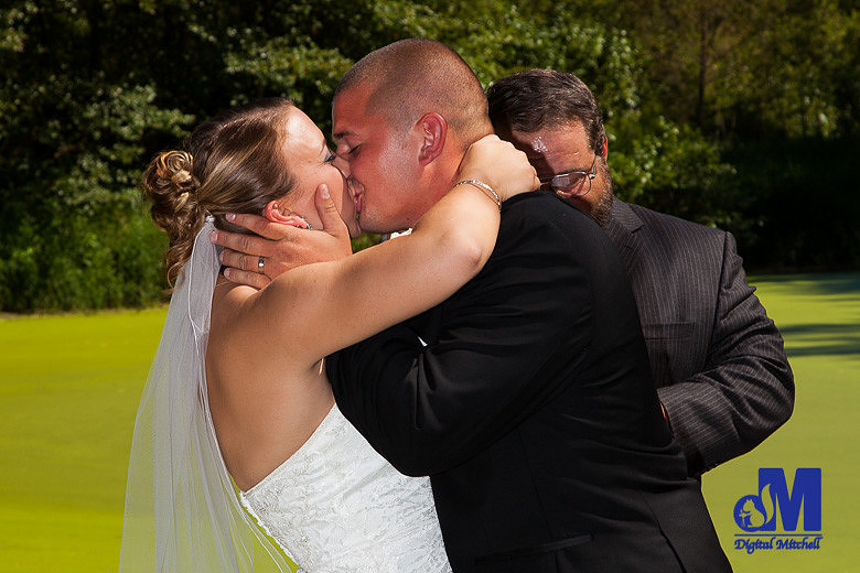 Photograph of bride and groom kissing