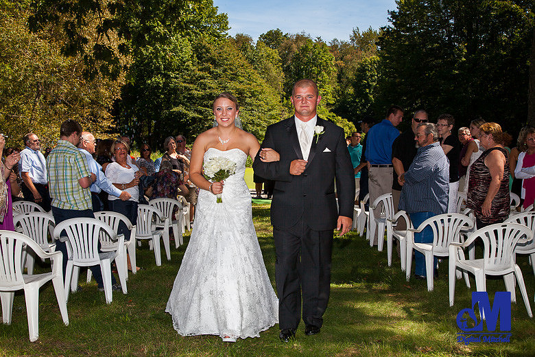 Photograph of bride and groom walking out