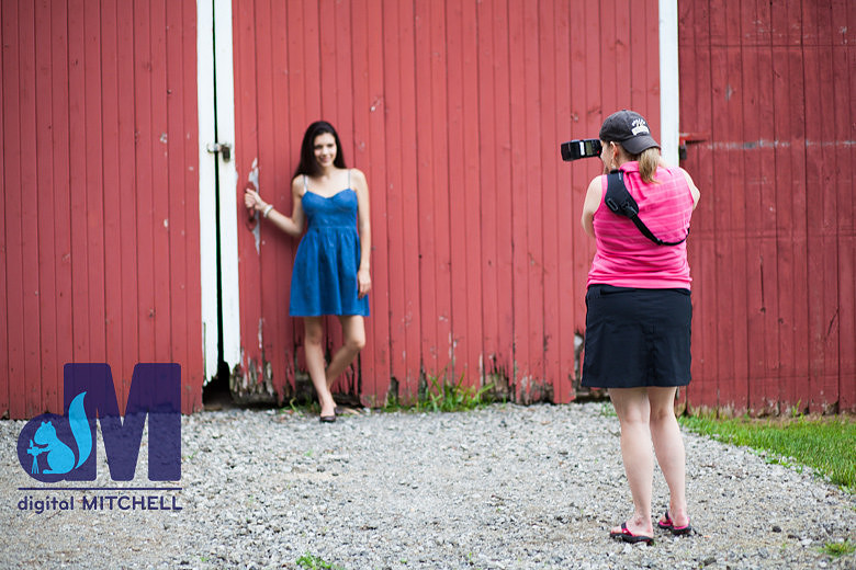 Dawn photographing senior girl by barn