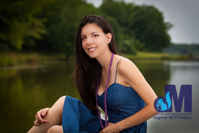 photograph of senior girl sitting by lake