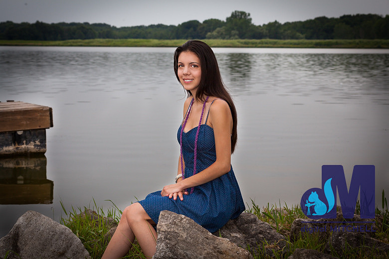 photograph of young lady next to lake