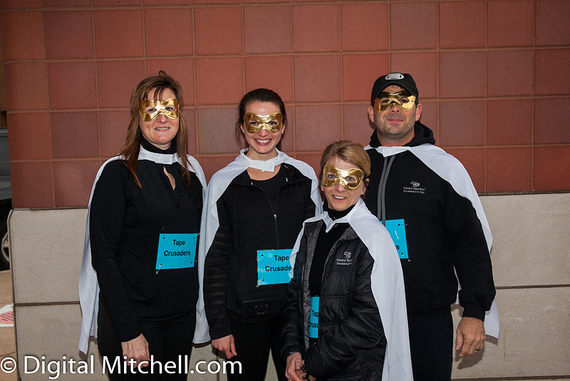 photograph of racers dressed in caps and golden masks