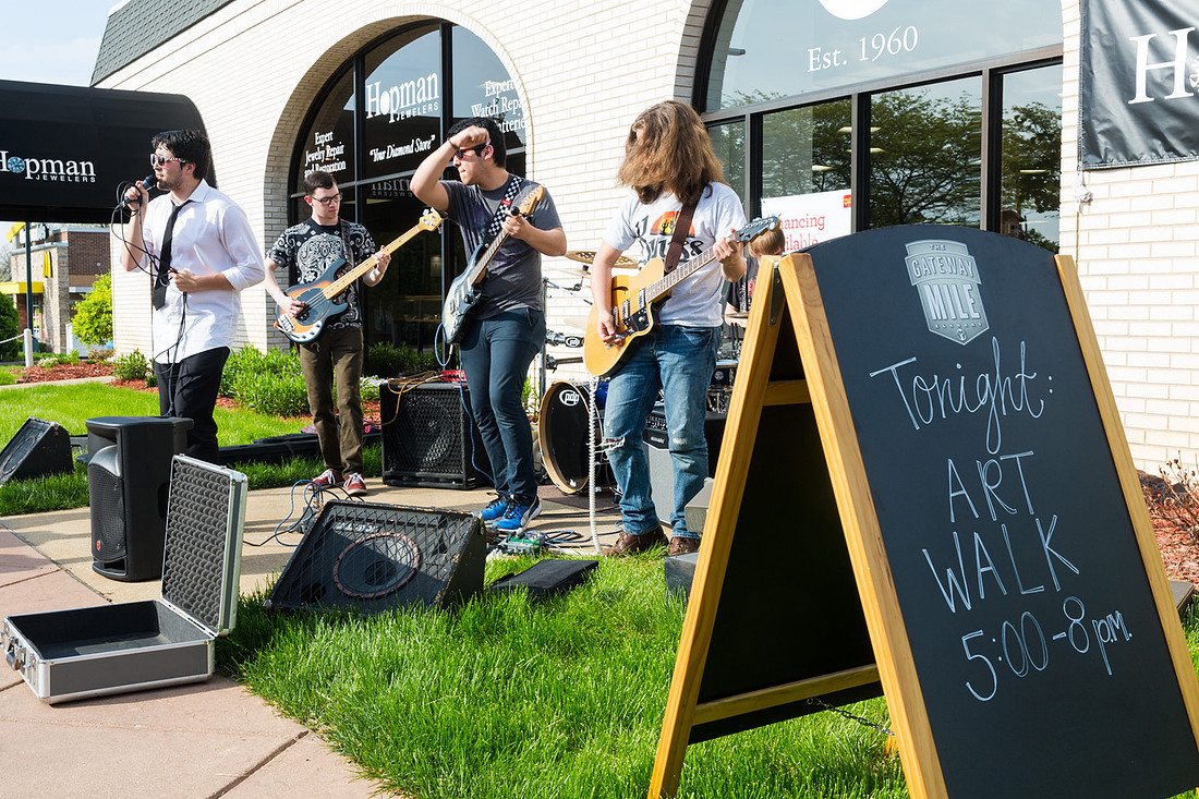 picture of band playing on sidewalk