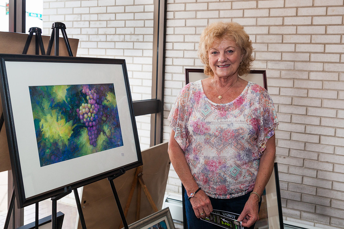 picture of artist with her fruit painting