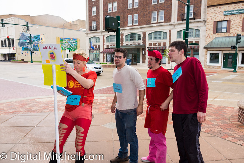 photograph of racers reading instructions