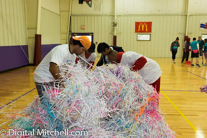 photograph of teams searching in strips of paper
