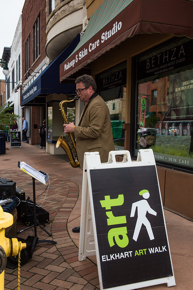 picture of man playing a saxophone on the street 