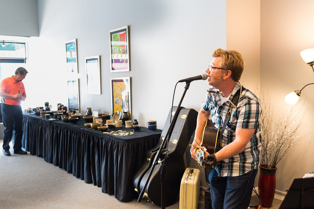 picture of guitarists playing indoors with art