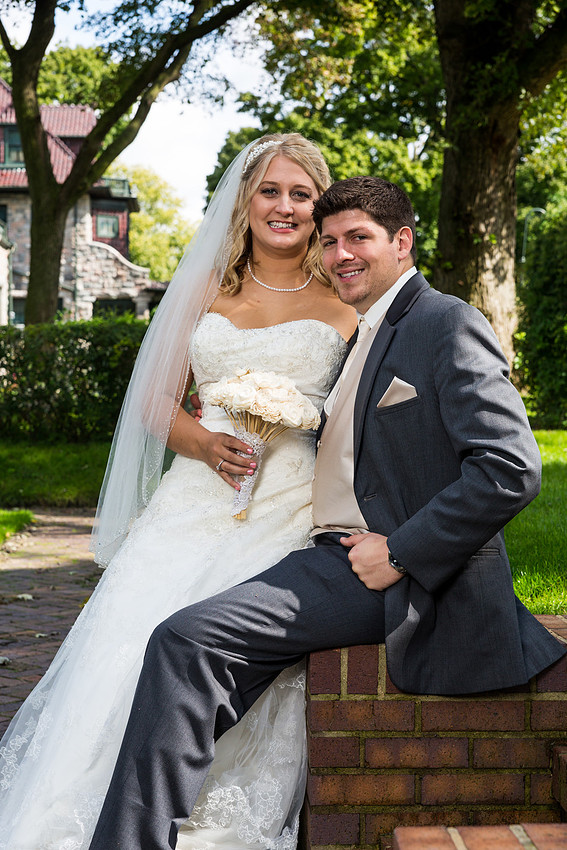 bride sitting on groom's knee