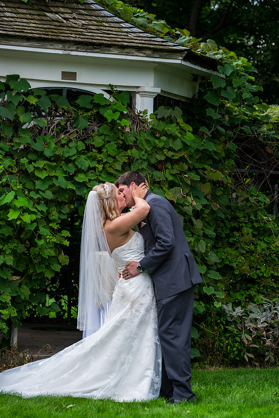 photo of the bride and groom kissing 