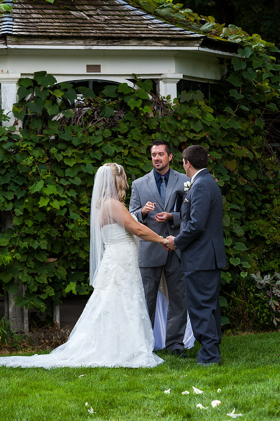 picture of bride and groom getting rings