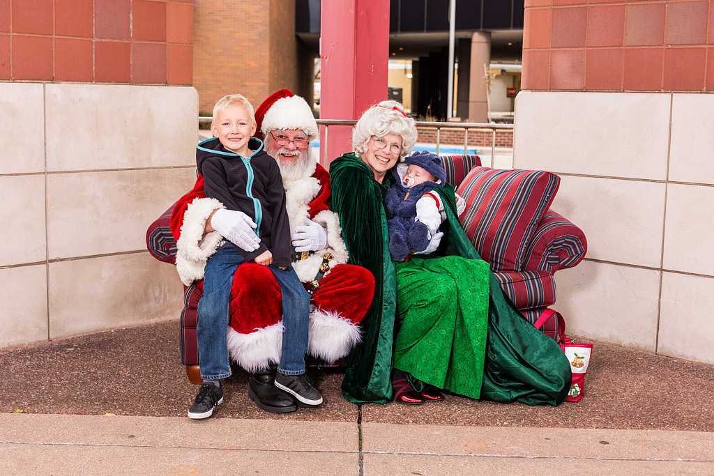 picture of a sleeping baby with Santa and Mrs. Claus