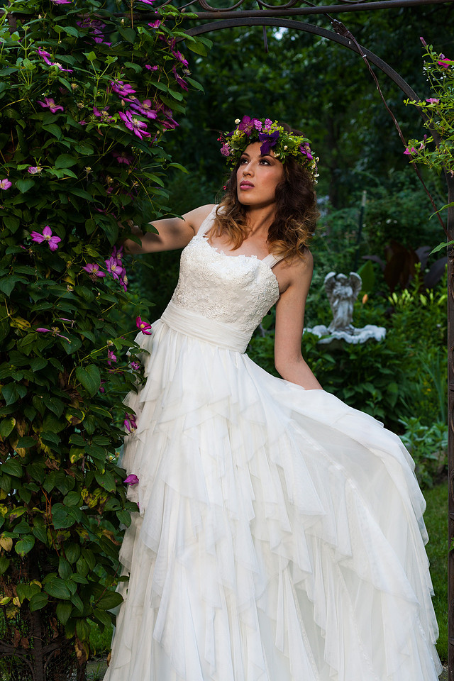 picture of bride in a wedding dress surrounded by purple flowers