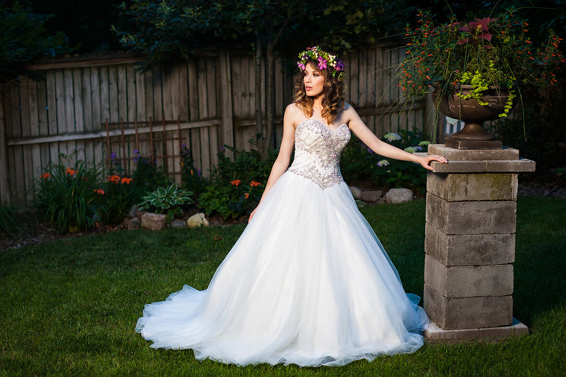 picture of bride in a wedding dress next to a plant