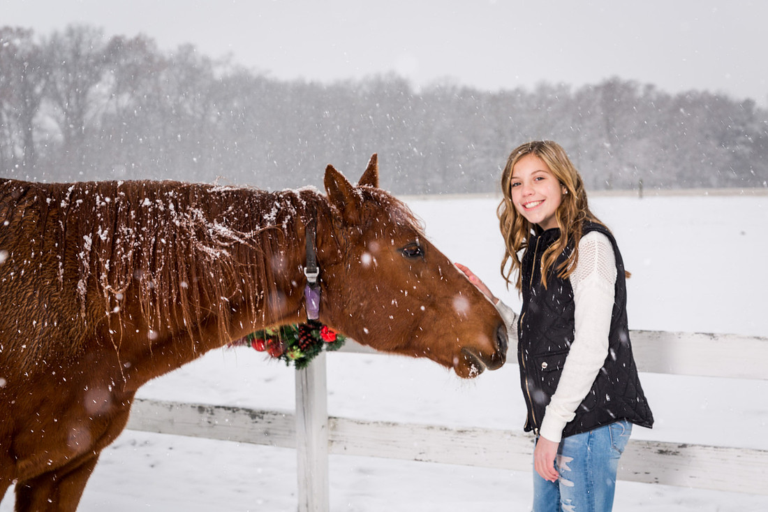 picture of girl and horse in the snow