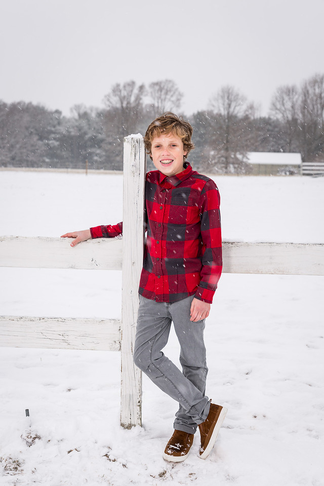 picture of boy in red against the snow