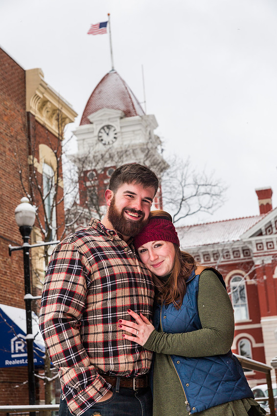 picture of engagement couple with city hall in the background