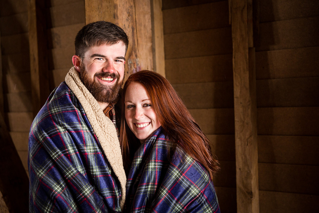 picture of a couple wrapped in blanket during  engagement photo session