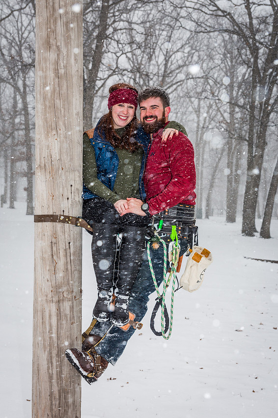 photograph of engaged couple on a poll climb