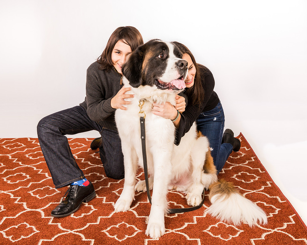 picture of two kids hugging their dog
