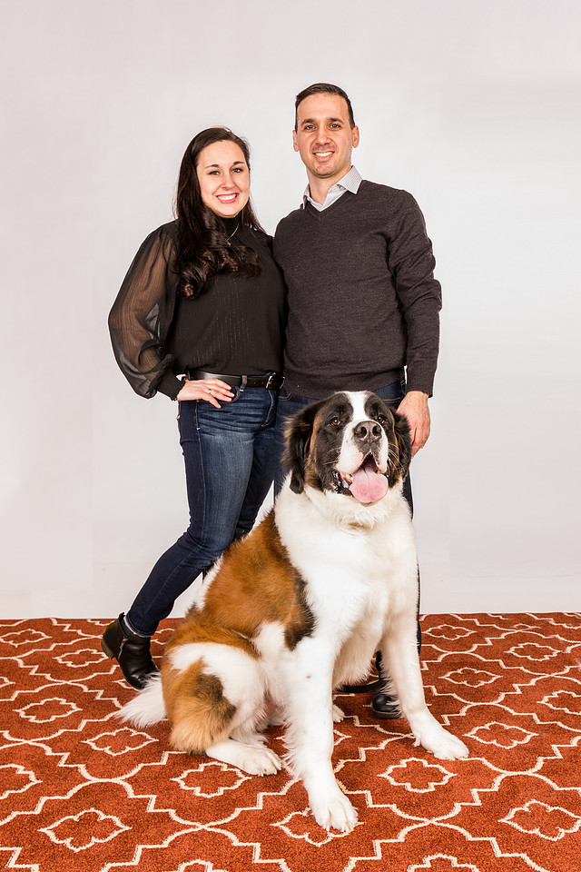 photograph of two parents with their dog