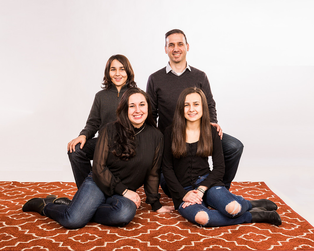 Portrait of the family sitting and kneeling
