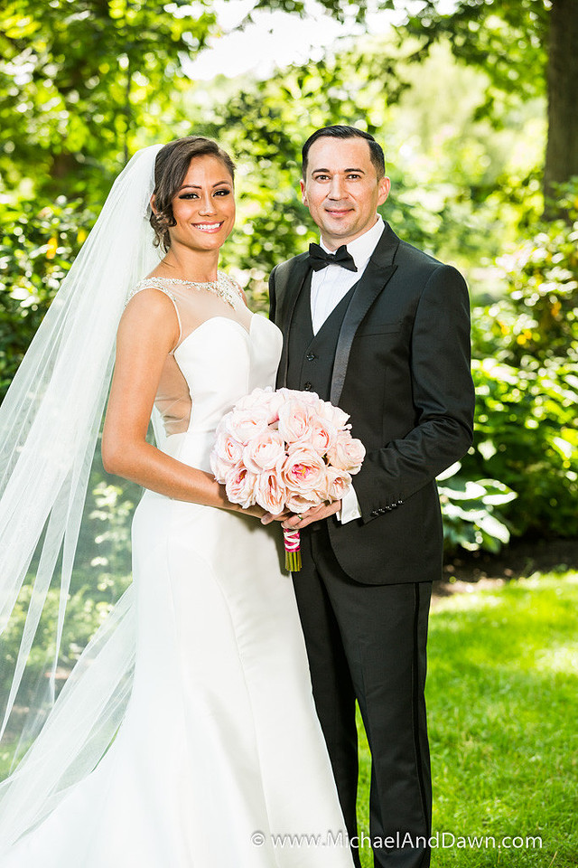 picture of bride with flowers and groom in the park