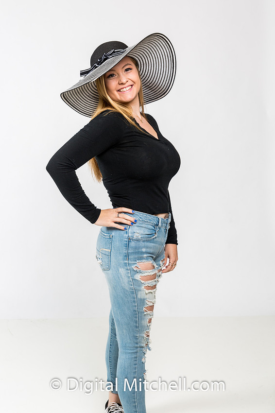 photo session of high school senior with big hat