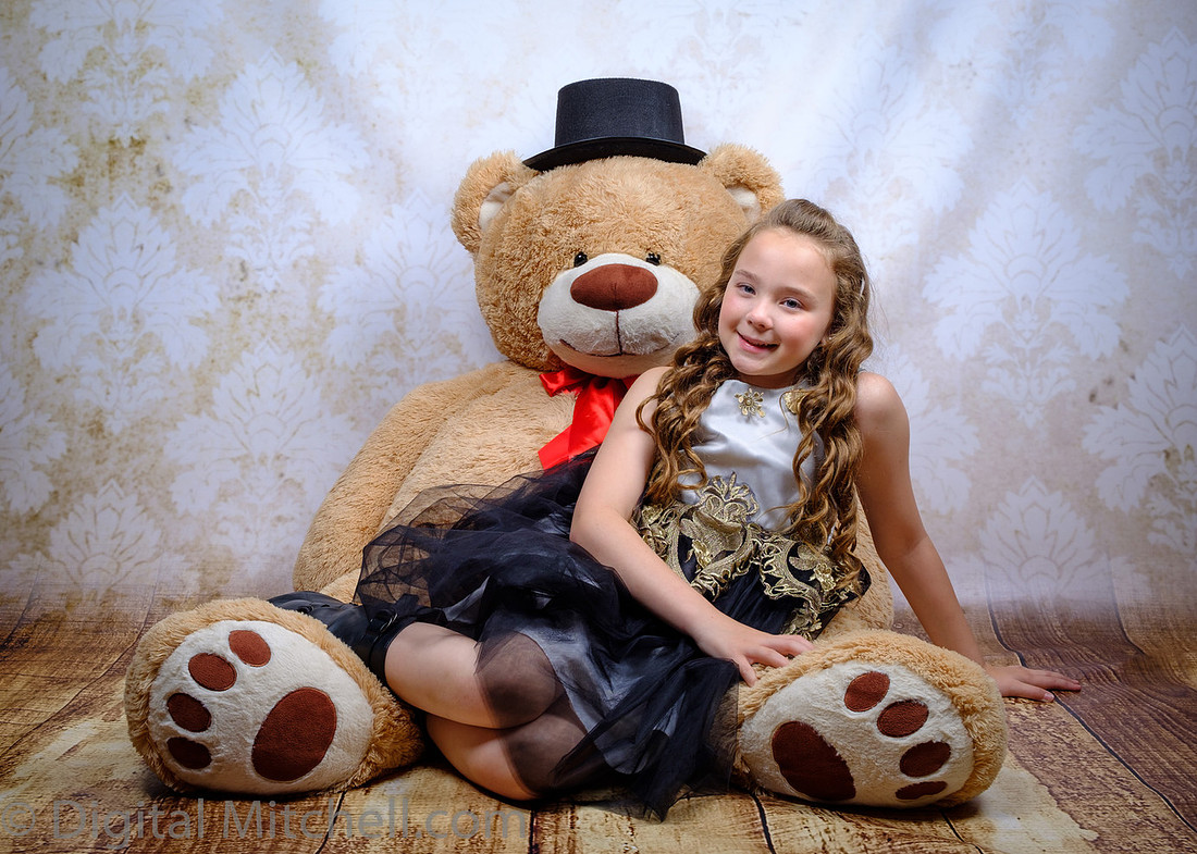 Photo with young girl and large stuffed bear