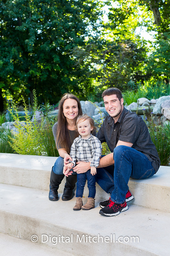 little girl with her parents for picture of family fall photo session