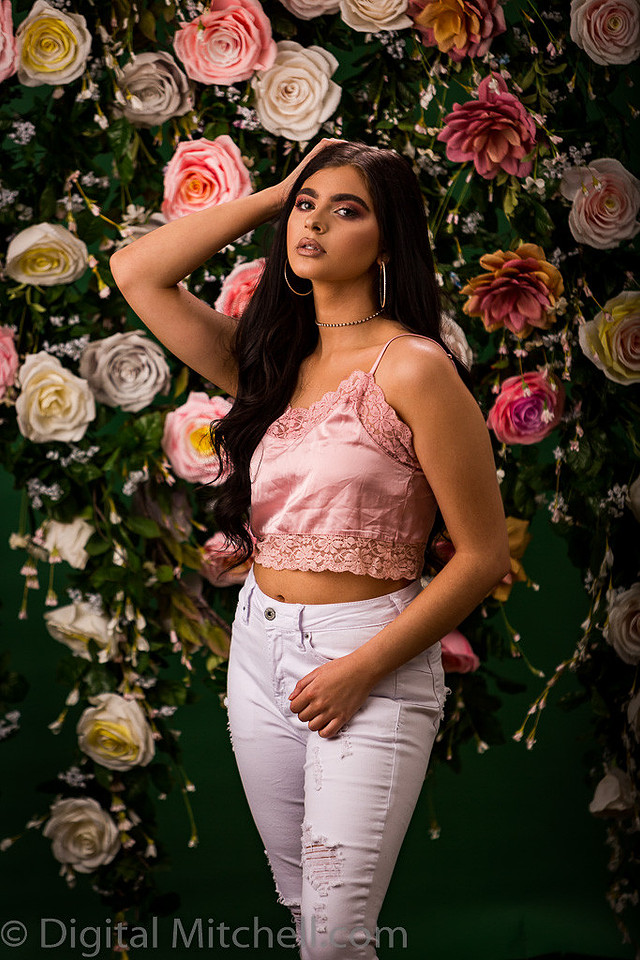 Picture of a young model in front of a Flower Wall