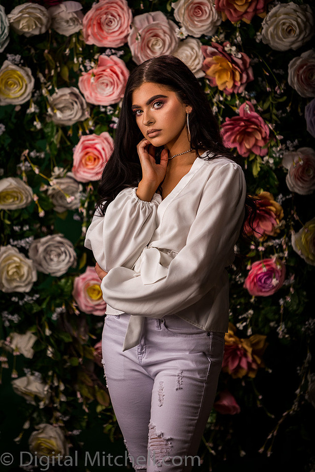 Picture of a young model in front of a Flower Wall
