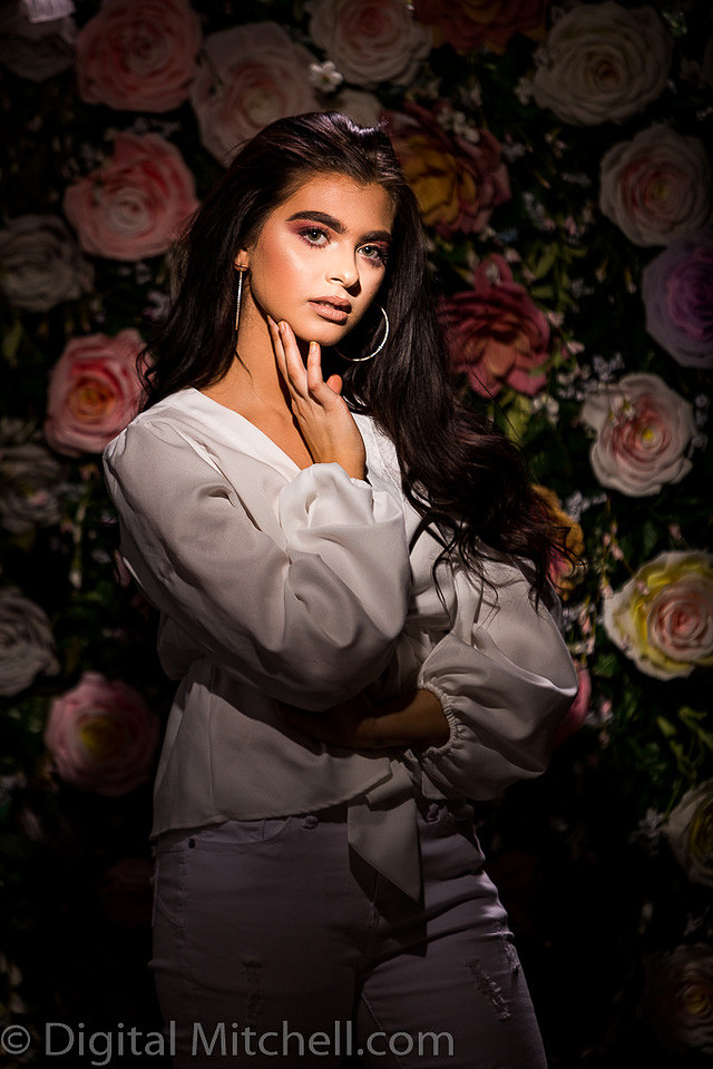 Picture of a young model in front of a Flower Wall
