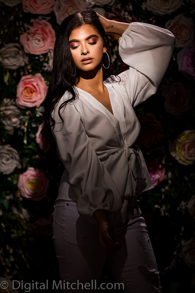 Picture of a young model in front of a Flower Wall