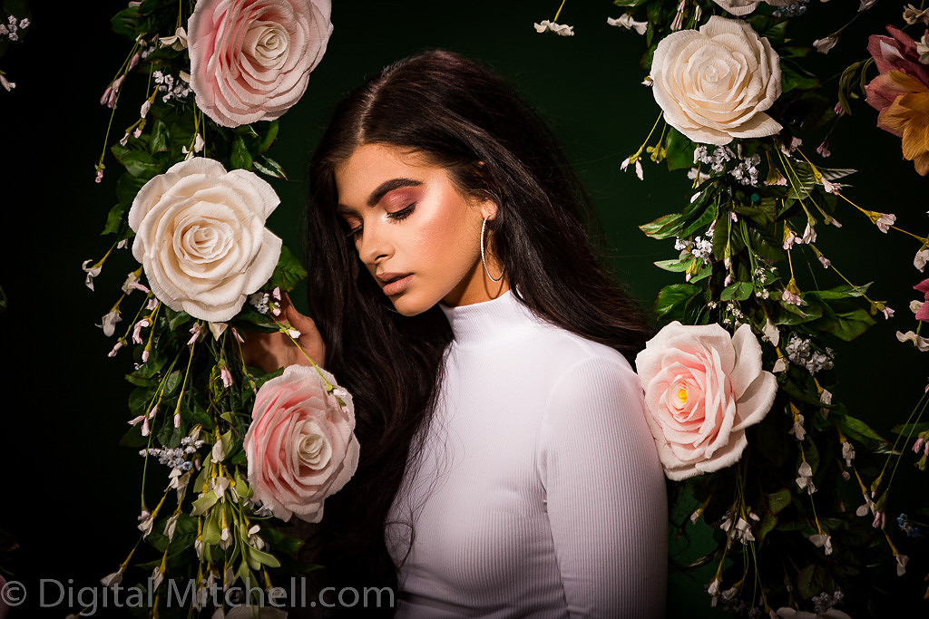 Picture of a young model in front of a Flower Wall