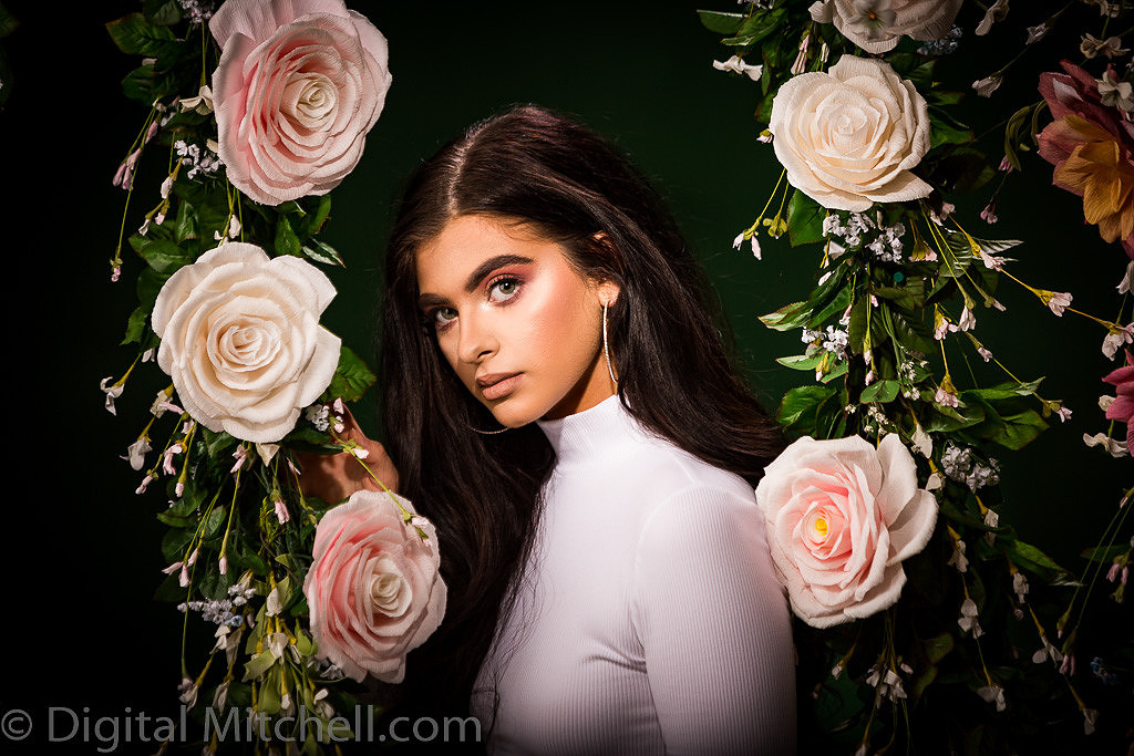 Picture of a young model in front of a Flower Wall